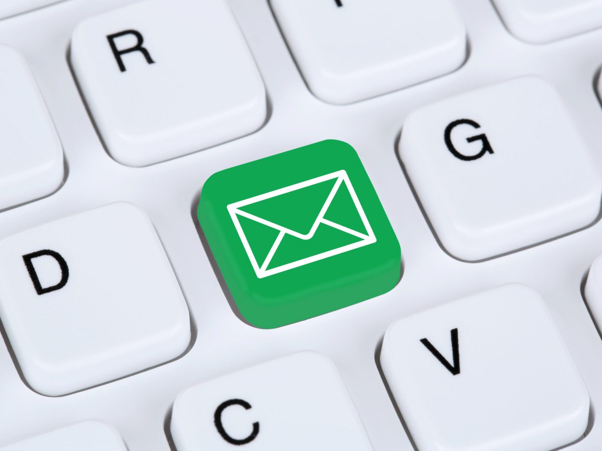 Sending E-Mail via internet on computer keyboard with letter symbol